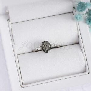 Unique black rutilated quartz ring with oval center stone and four round accents.