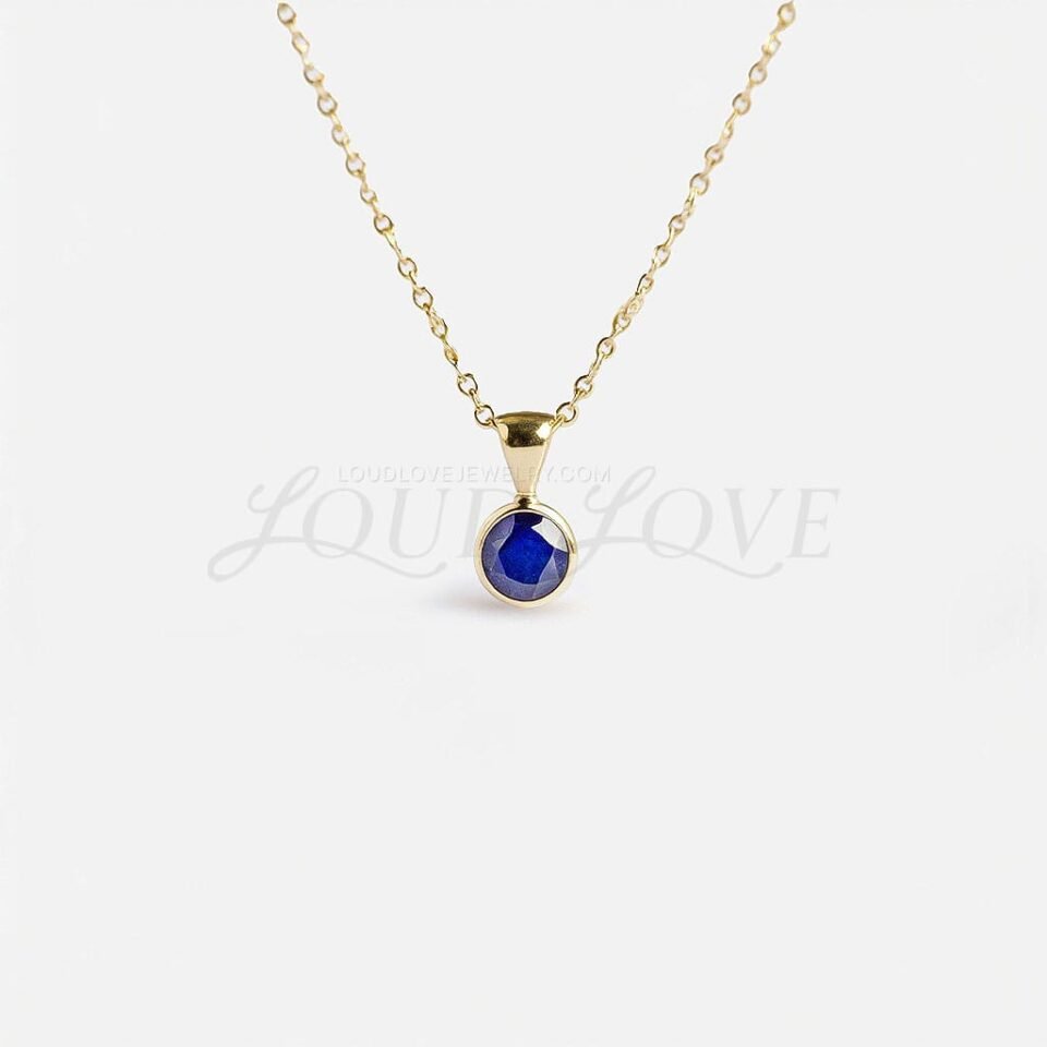 Round blue lab sapphire in a yellow gold bezel, classic symbol of September.