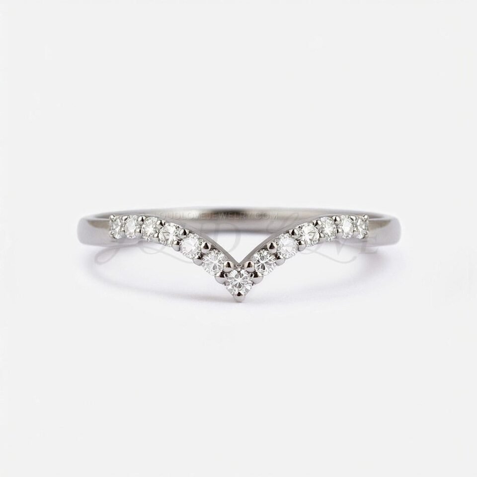 Eternity ring with subtle V shape and moissanites set across the band, front-facing.
