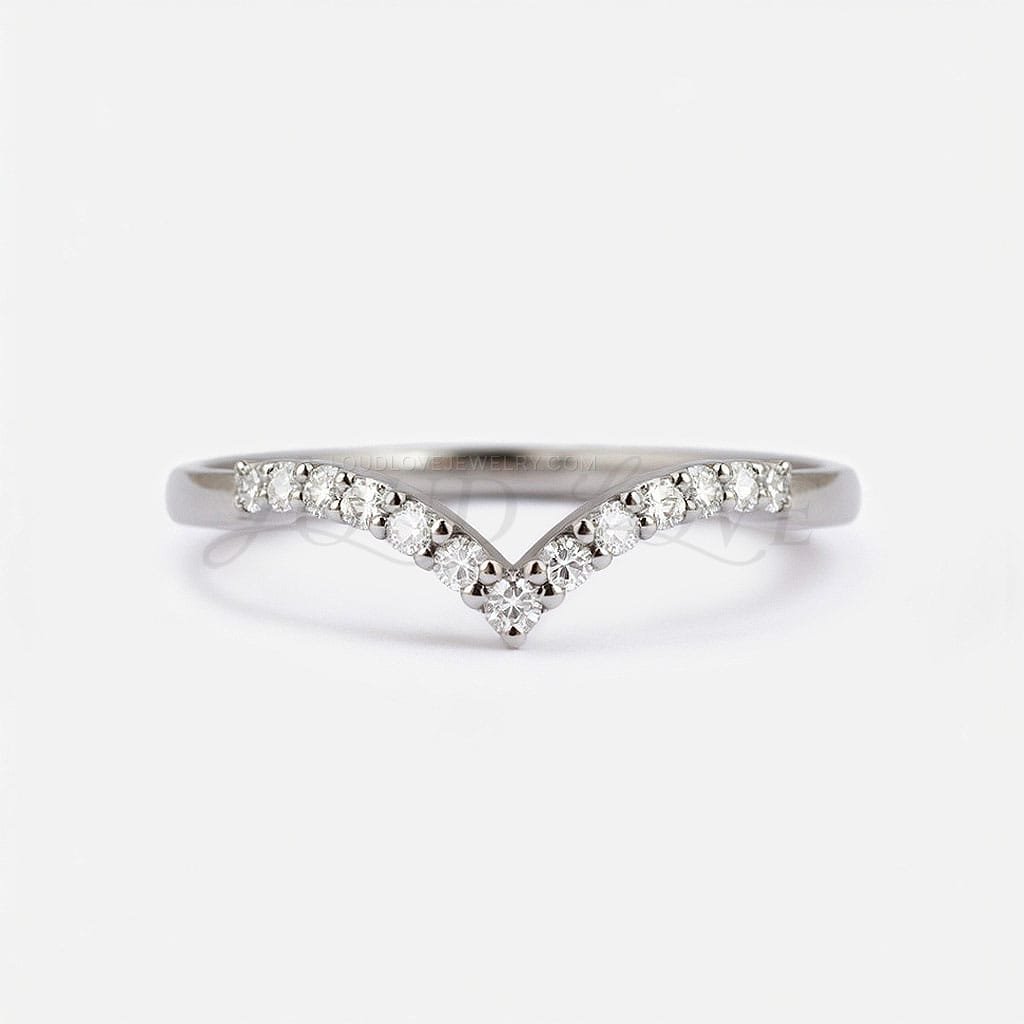 Eternity ring with subtle V shape and moissanites set across the band, front-facing.