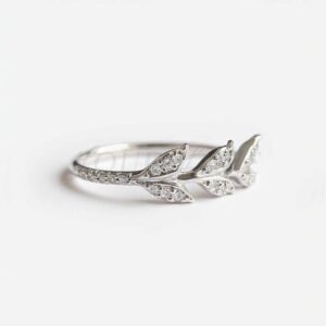 Silver ring with elegant leaf design and sparkling accents.