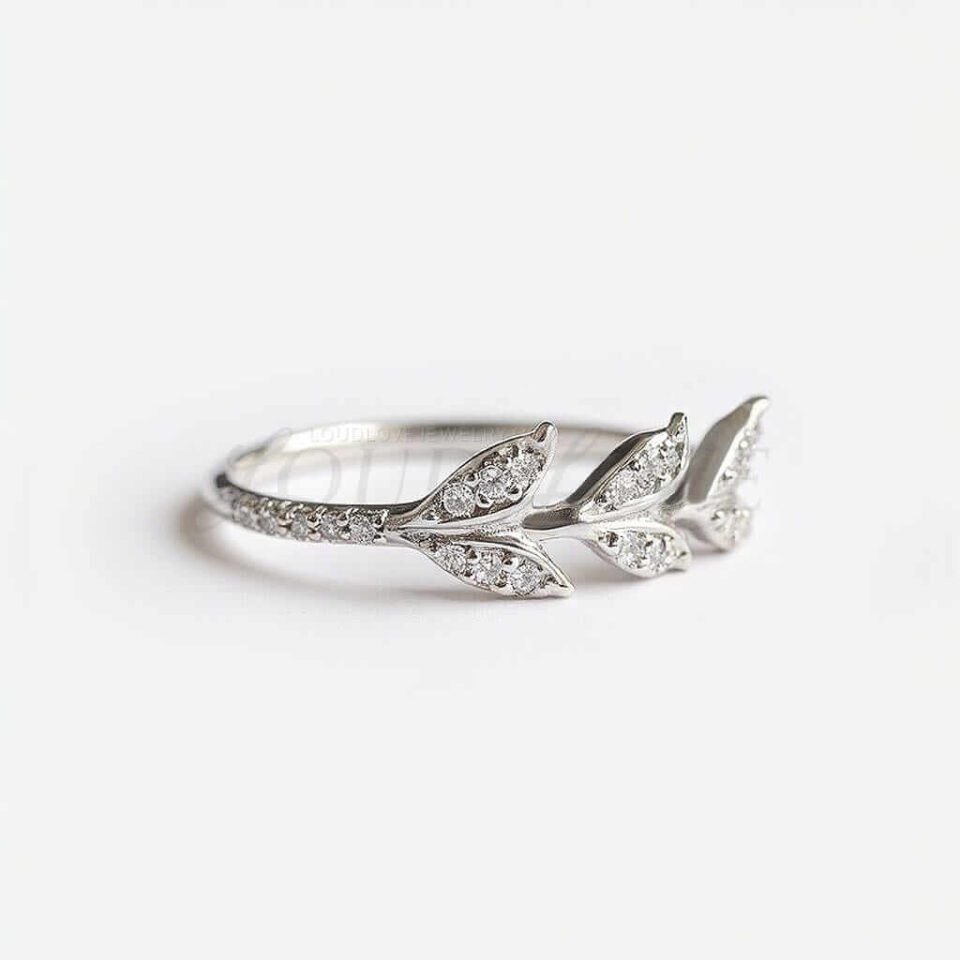 Silver ring with elegant leaf design and sparkling accents.