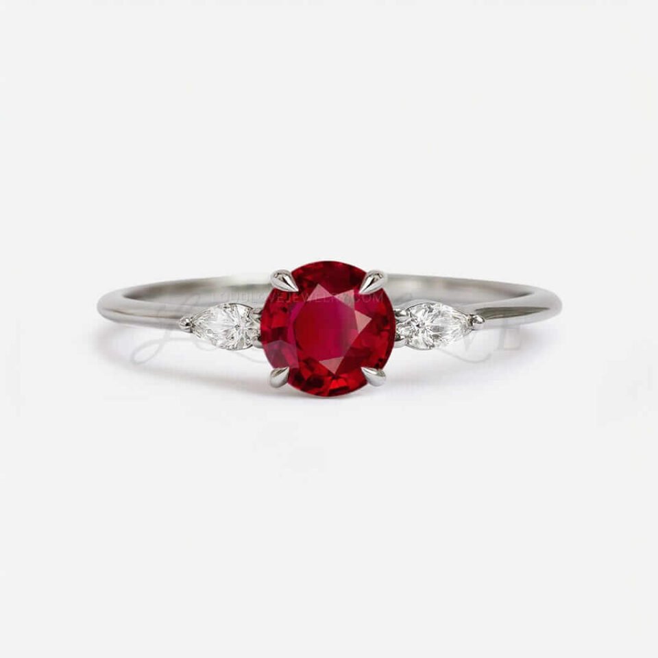 Sterling silver ring with round ruby center and marquise white stones in claw prongs.