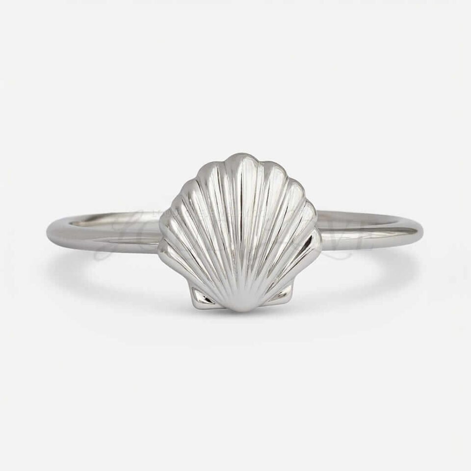 Silver shell ring with detailed ridged design.
