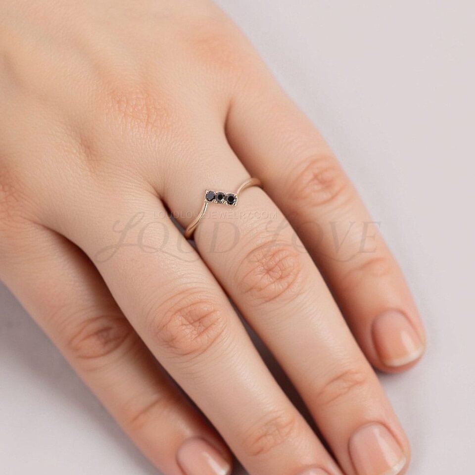 Delicate 3-stone pave ring featuring round diamonds with a curved band.
