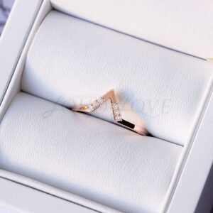 V-shaped gold ring with six moissanites presented in a jewelry box.