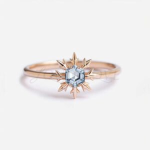 Hexagon aquamarine in a rose gold snowflake setting on a thin band.