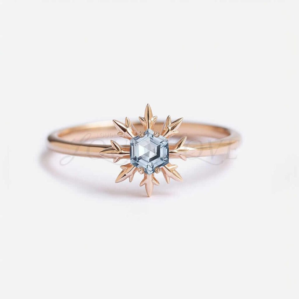 Hexagon aquamarine in a rose gold snowflake setting on a thin band.