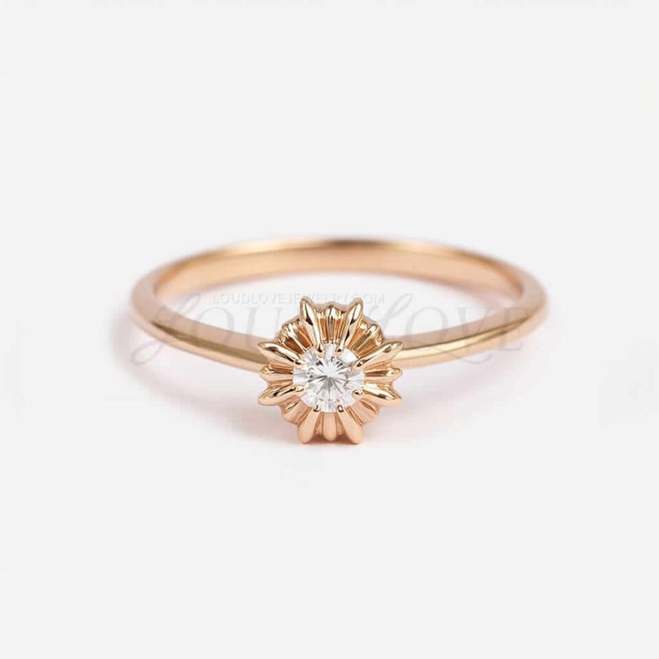 Small lab-grown diamond ring with a gold sunburst design.