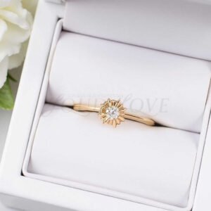 Starburst ring with lab-grown diamond and golden halo shaped like sunrays.