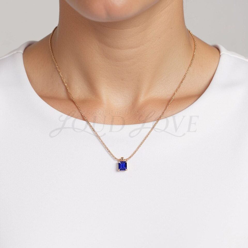 Deep violet-blue tanzanite pendant styled in rose gold, worn as a December birthstone accessory.
