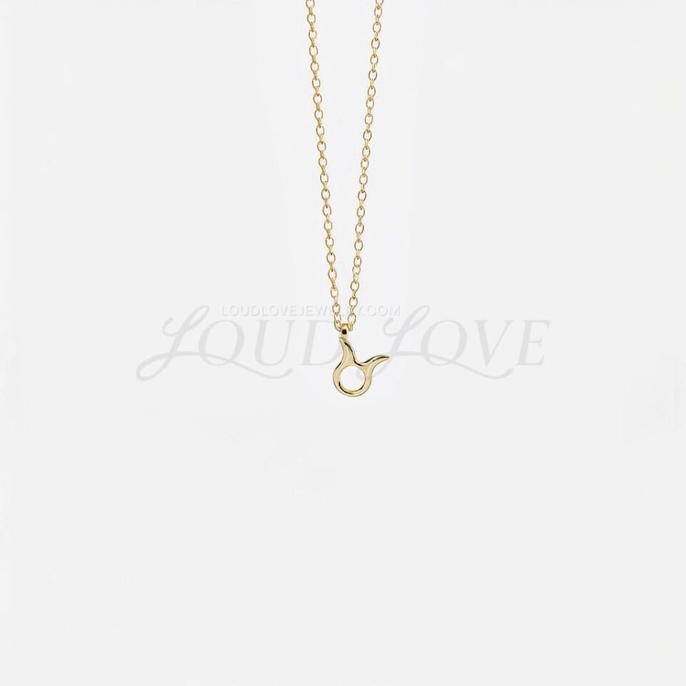 Taurus zodiac necklace with polished gold bull symbol pendant on a fine chain.
