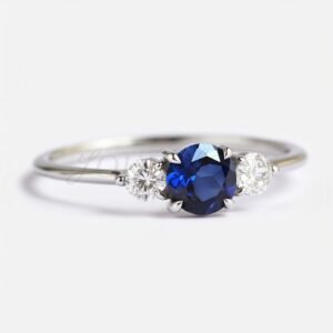 Side view of round lab-grown sapphire ring with white stone accents.