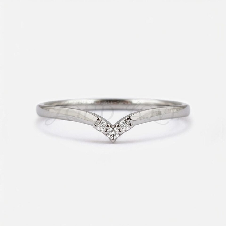 Shallow V-shaped gold stacking ring with three round stones in a symmetrical layout.