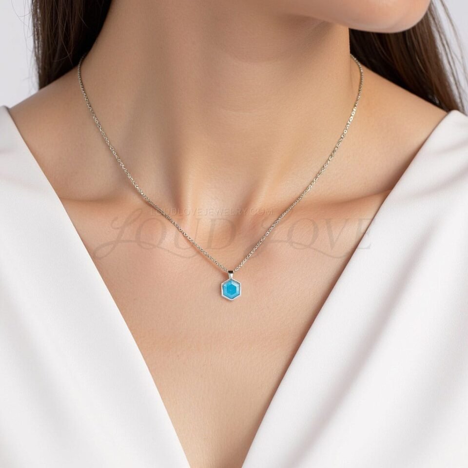 Geometric turquoise pendant styled with silver and gold tones, offering a fresh, modern design.