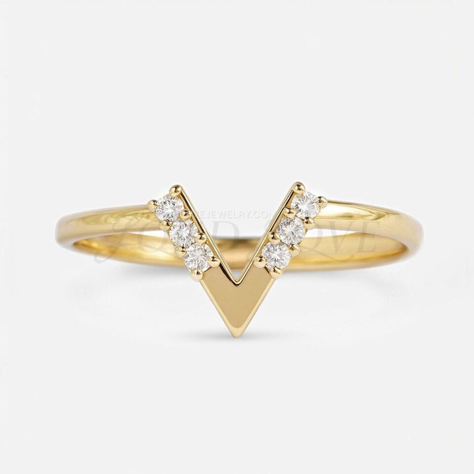 Stackable gold ring with V silhouette and six sparkling moissanites in front view.