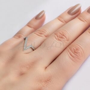 Modern asymmetrical wedding band in gold with round moissanites in a V design.