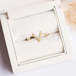 V-shaped gold ring displayed in an elegant presentation case.