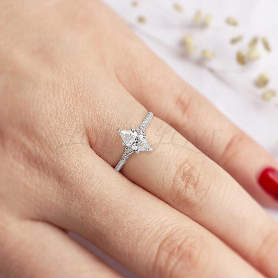 Marquise moissanite ring with vintage-inspired milgrain-edge band, shown worn on hand.