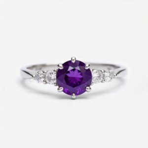 Large round amethyst flanked by four moissanite stones in a white gold five-stone engagement ring.