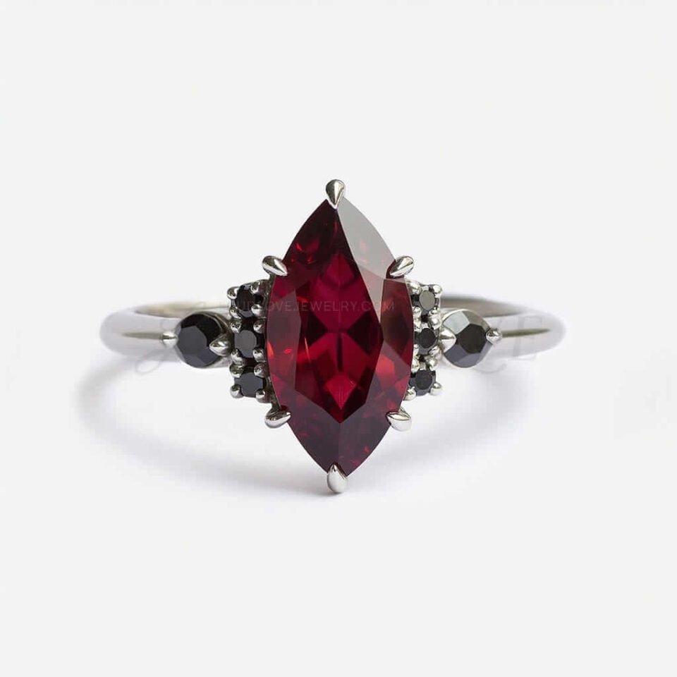 Marquise-cut garnet with black moissanite accents in a bold, mystical setting full of dark elegance.