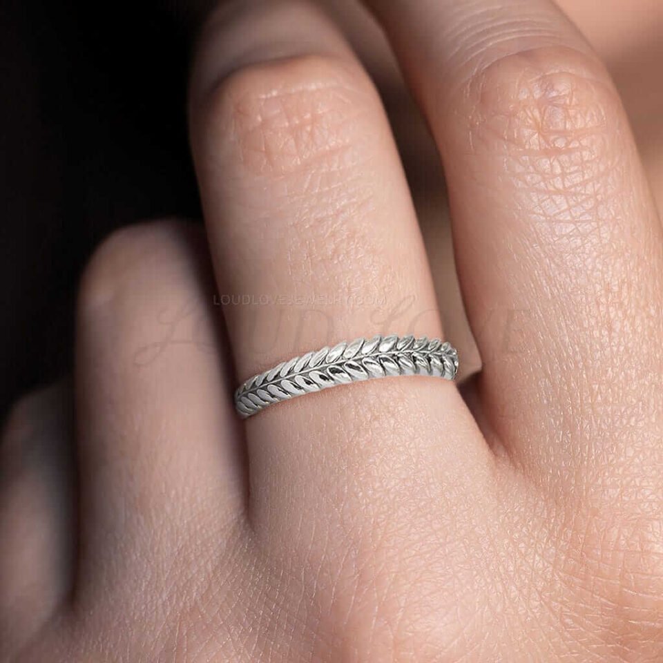 Ring with a braided leaf pattern, symbolizing nature.